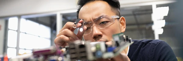 A man looking at a motherboard